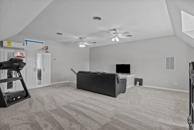 workout area with a textured ceiling, light colored carpet, vaulted ceiling, and ceiling fan