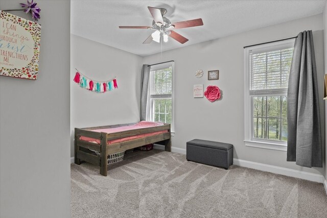 carpeted bedroom featuring ceiling fan