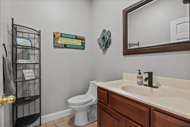 bathroom featuring tile patterned flooring, vanity, and toilet