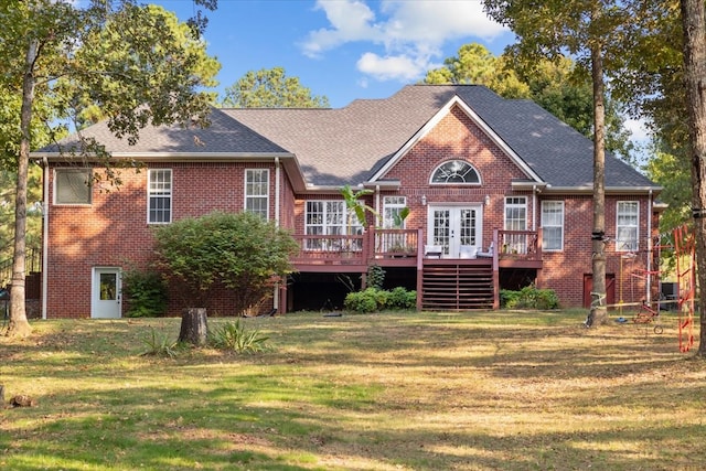 rear view of house featuring a wooden deck and a yard