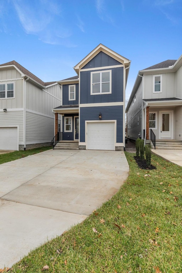 view of front of home with a front yard and a garage