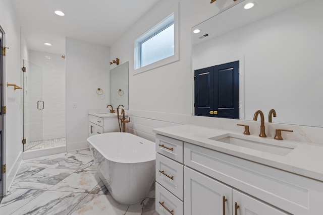 bathroom featuring vanity and independent shower and bath