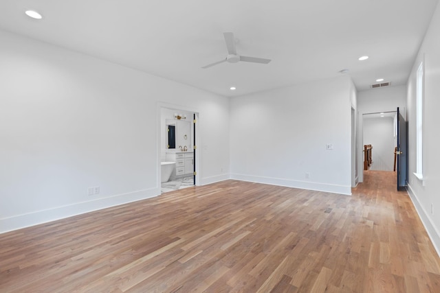 empty room featuring light wood-type flooring and ceiling fan