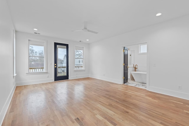 foyer entrance featuring ceiling fan and light wood-type flooring