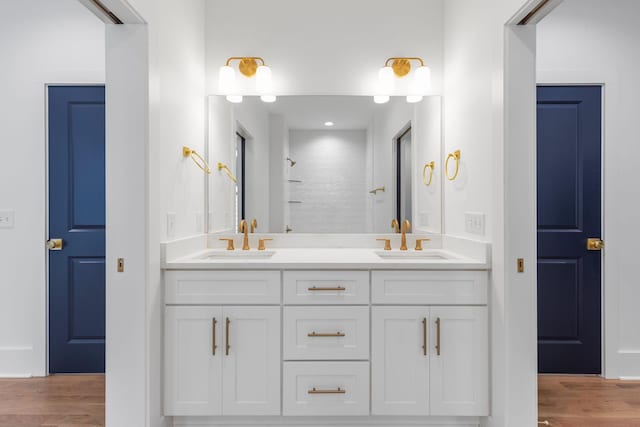 bathroom featuring a shower, hardwood / wood-style floors, and vanity