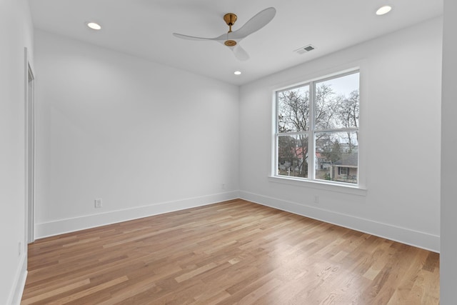 unfurnished room featuring a wealth of natural light, light hardwood / wood-style flooring, and ceiling fan