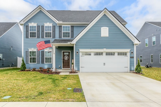 view of front of property featuring a garage and a front lawn