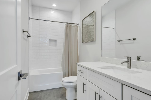 full bathroom with tile patterned flooring, vanity, shower / bath combo with shower curtain, and toilet