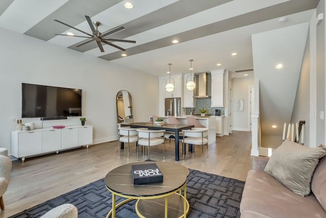 living room with light wood-type flooring and ceiling fan