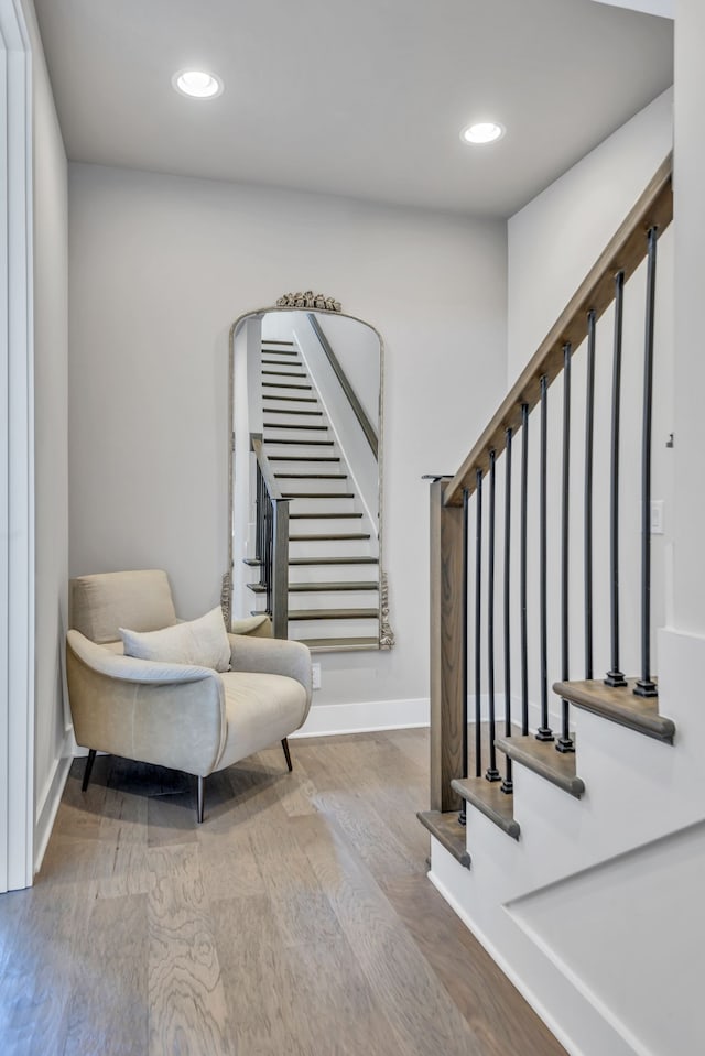 staircase with hardwood / wood-style floors