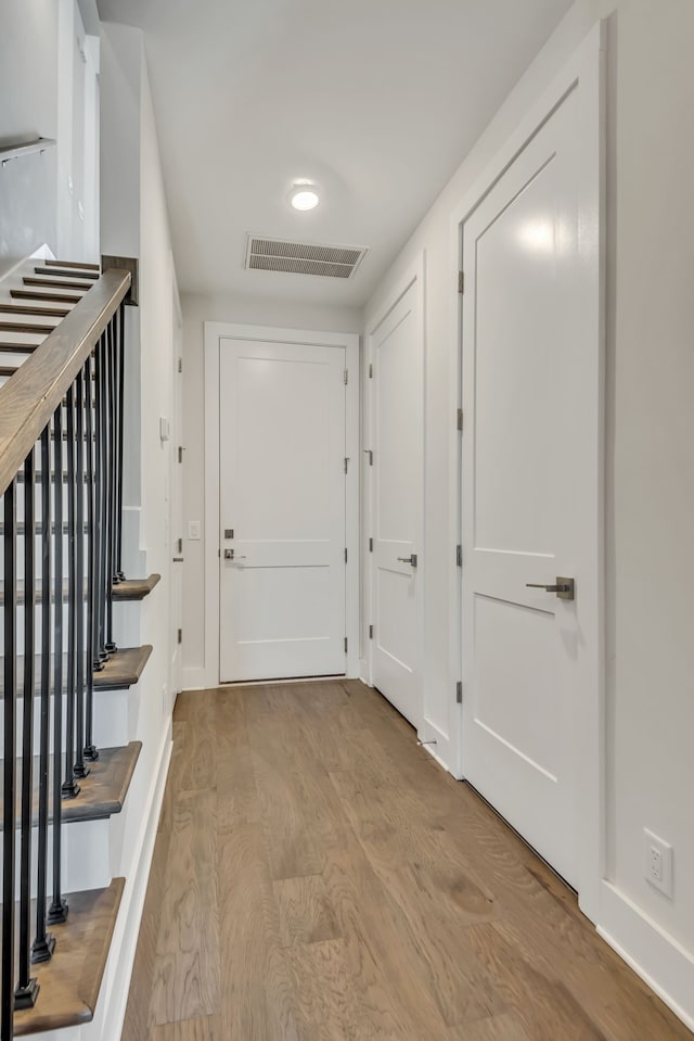 hall with light hardwood / wood-style floors