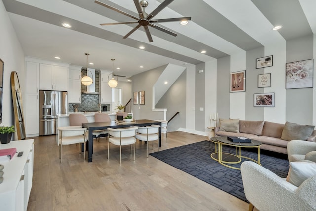 living room with light wood-type flooring and ceiling fan