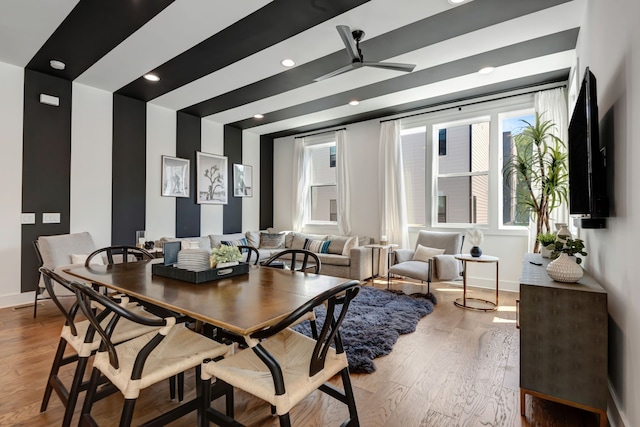 dining area featuring wood-type flooring and ceiling fan