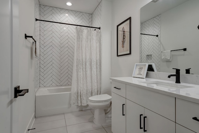 full bathroom with shower / tub combo with curtain, tile patterned floors, vanity, and toilet