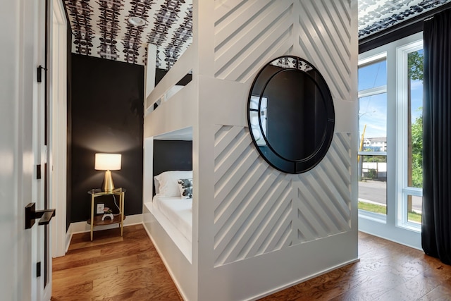 bedroom with hardwood / wood-style flooring and multiple windows