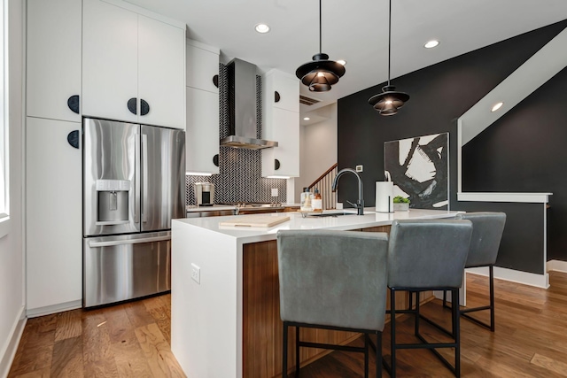 2176 Carson St Unit 23, Nashville, TN 37211 - kitchen with stainless steel fridge, wall chimney range hood, modern cabinets, white cabinets, and light countertops