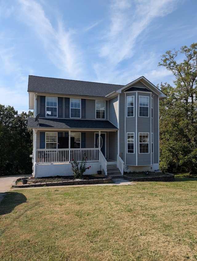 view of front of home with a front lawn and covered porch