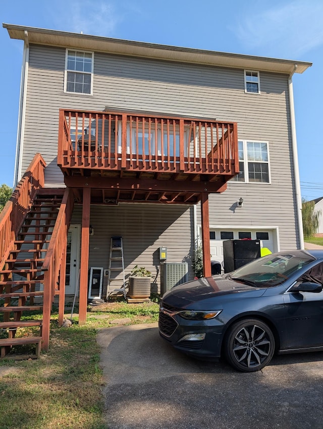 back of house with stairs, central AC unit, and a wooden deck