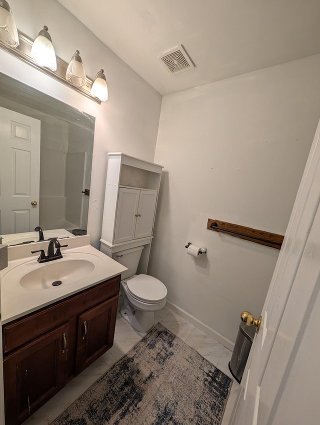 bathroom featuring vanity, visible vents, toilet, marble finish floor, and baseboards