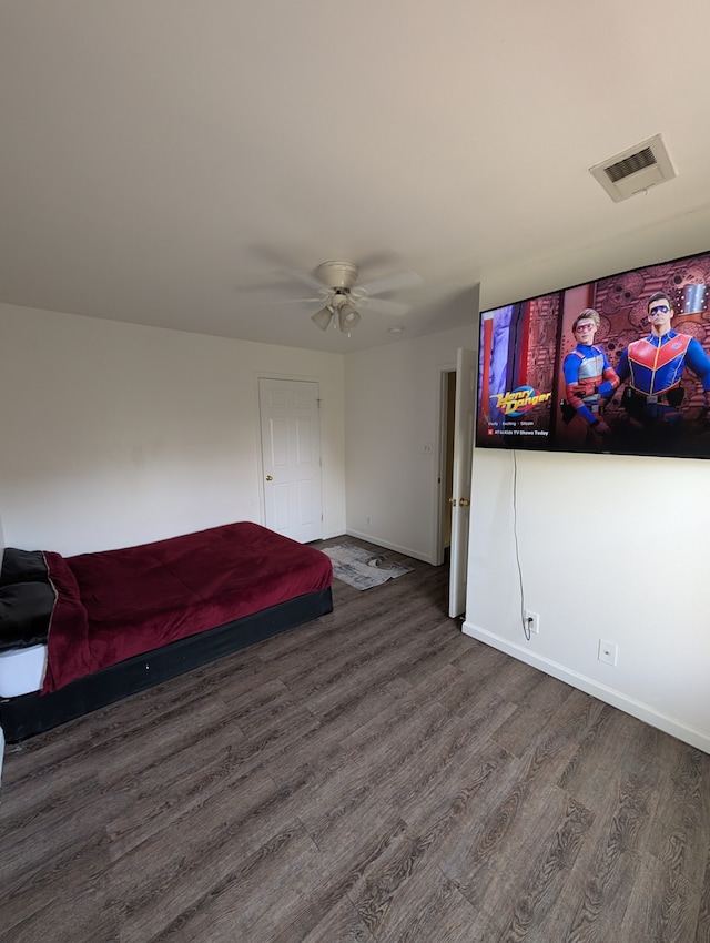 unfurnished bedroom featuring ceiling fan and dark wood-type flooring