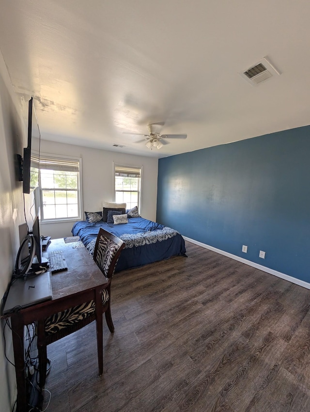 bedroom featuring visible vents, ceiling fan, wood finished floors, and baseboards