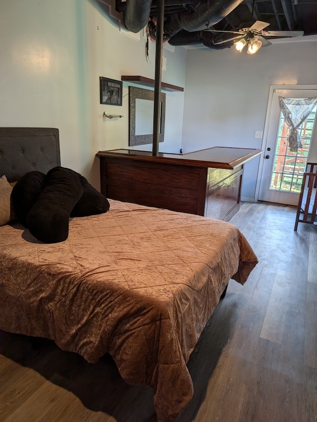 bedroom featuring hardwood / wood-style flooring, ceiling fan, and access to exterior