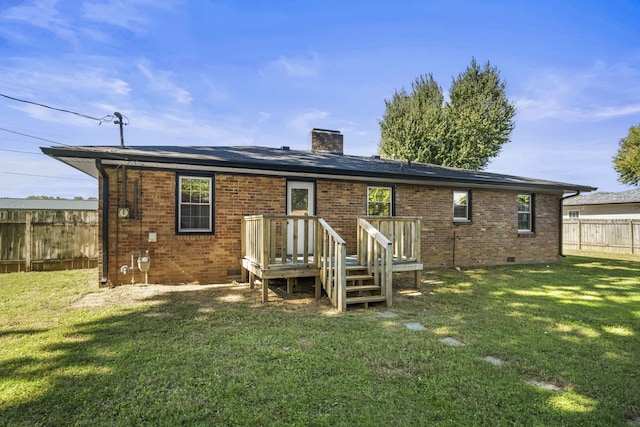 rear view of house featuring a yard