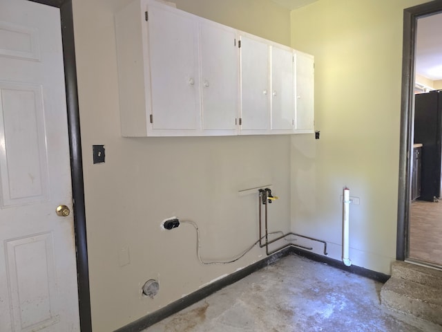 laundry room featuring cabinets