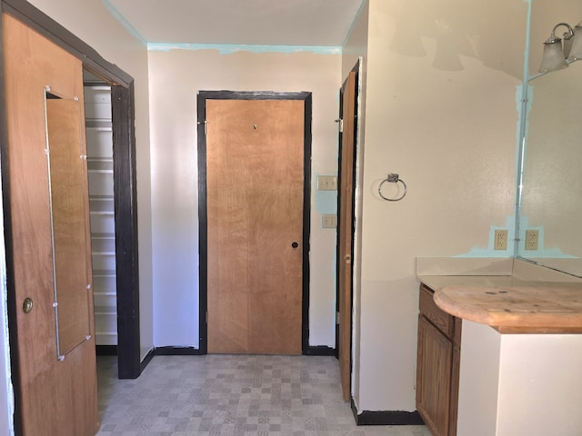 bathroom with vanity and crown molding