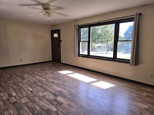 spare room featuring dark hardwood / wood-style floors and ceiling fan