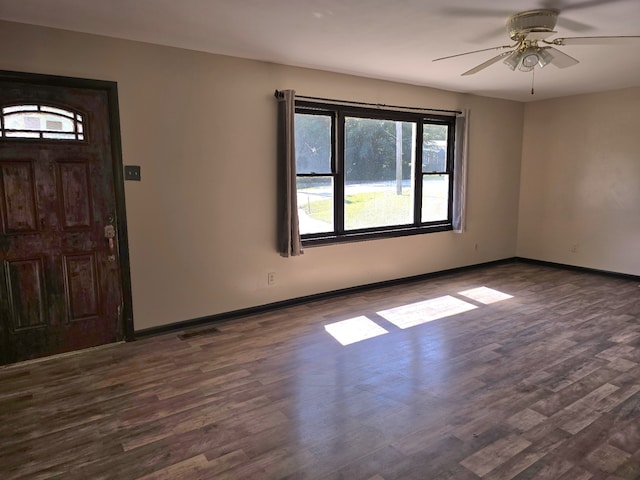 entryway with dark wood-type flooring and ceiling fan