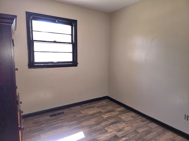 unfurnished room featuring dark hardwood / wood-style floors