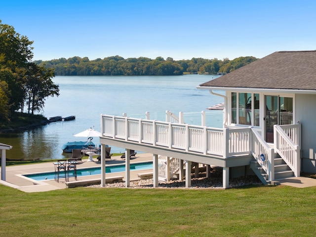 dock area featuring a pool side deck with water view and a yard