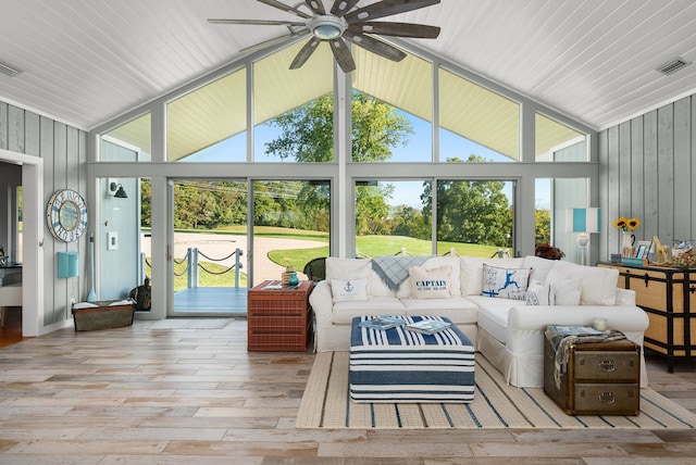 sunroom / solarium with ceiling fan and vaulted ceiling