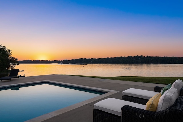 pool at dusk with a water view