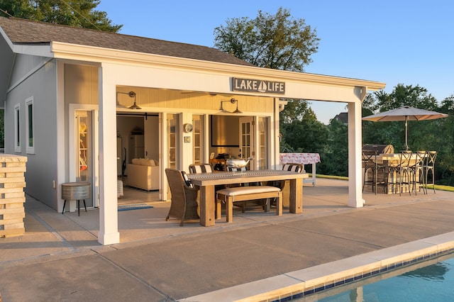 view of patio with a bar and an outdoor structure