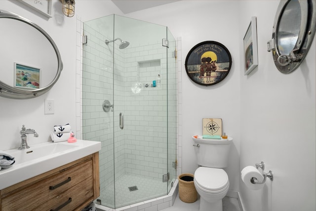 bathroom featuring walk in shower, vanity, and toilet