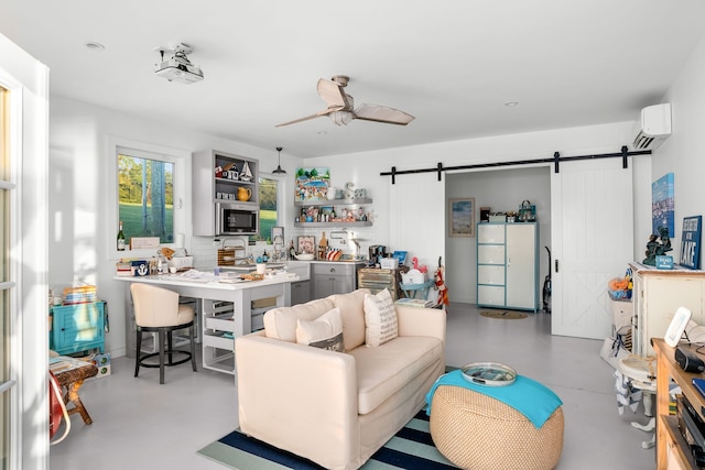 living room with a wall mounted air conditioner, ceiling fan, and a barn door