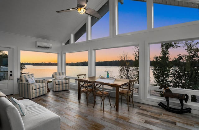 sunroom / solarium with a wall unit AC, a water view, and lofted ceiling with beams