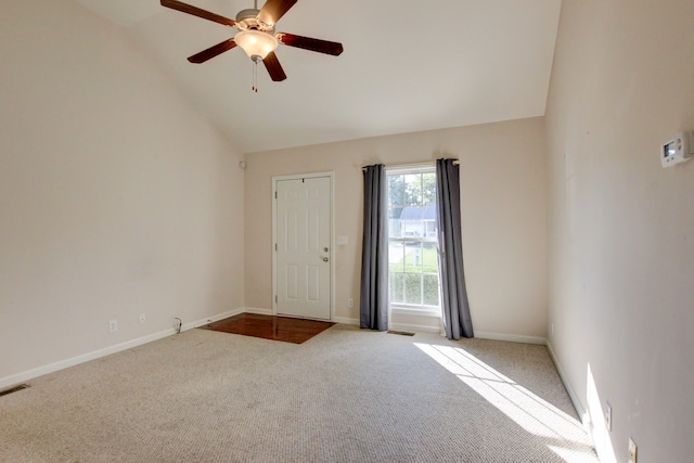 carpeted spare room featuring ceiling fan and lofted ceiling