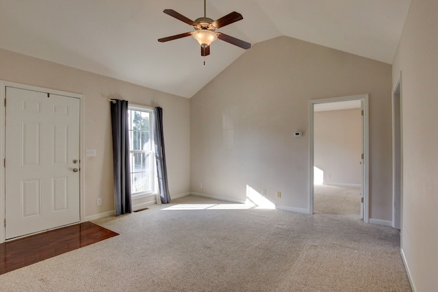 carpeted foyer entrance with high vaulted ceiling and ceiling fan