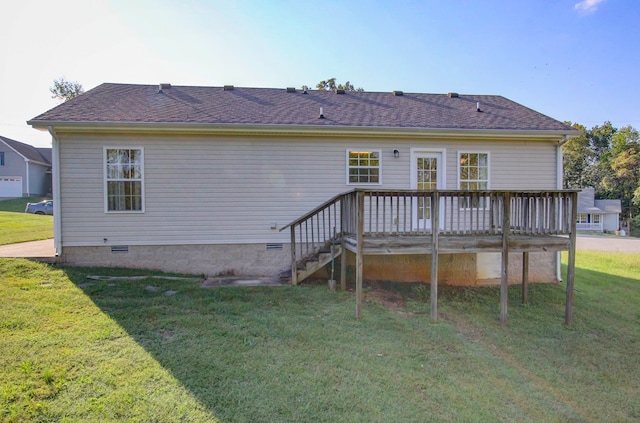 rear view of house with a deck and a yard