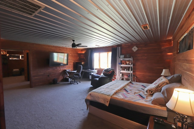 carpeted bedroom featuring wood walls