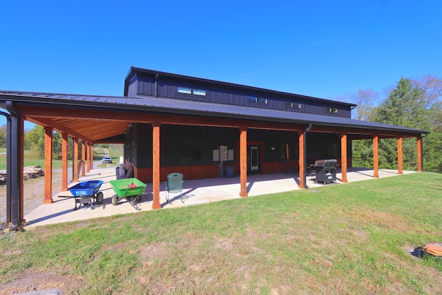 rear view of property featuring a gazebo, a lawn, and a patio area