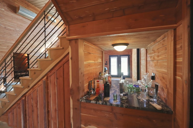 bar featuring wood walls, french doors, and wooden ceiling