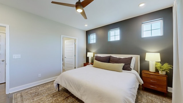 bedroom featuring dark hardwood / wood-style flooring and ceiling fan