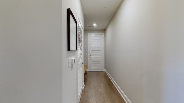 hallway with light hardwood / wood-style flooring