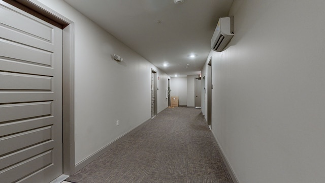 hallway with carpet flooring and a wall unit AC