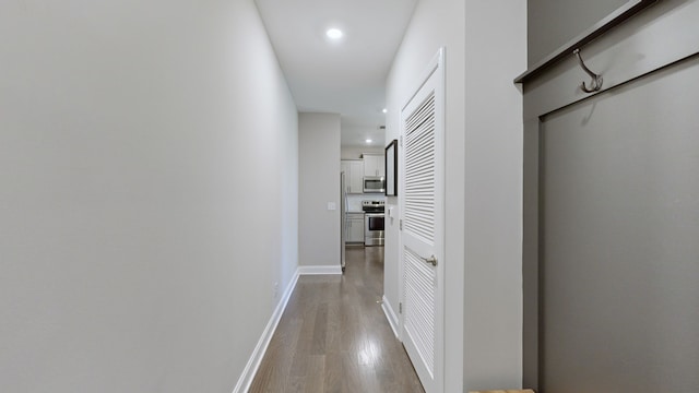 corridor with wood-type flooring