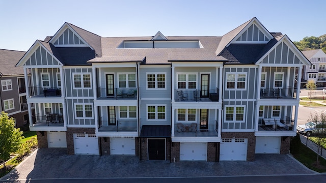 back of house featuring a garage and a balcony